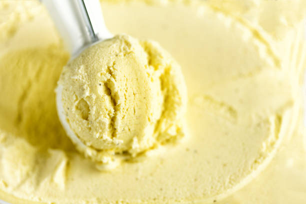 istock Vanilla ice cream scoop background. Summer food concept, copy space, top view. Scooped texture. Scooping out yellow ice-cream 956366128
