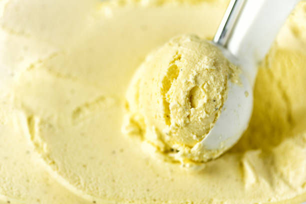 istock Vanilla ice cream scoop background. Summer food concept, copy space, top view. Scooped texture. Scooping out yellow ice-cream 956366166