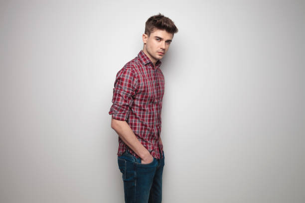 istock side view of young man with hands in pockets 956366572