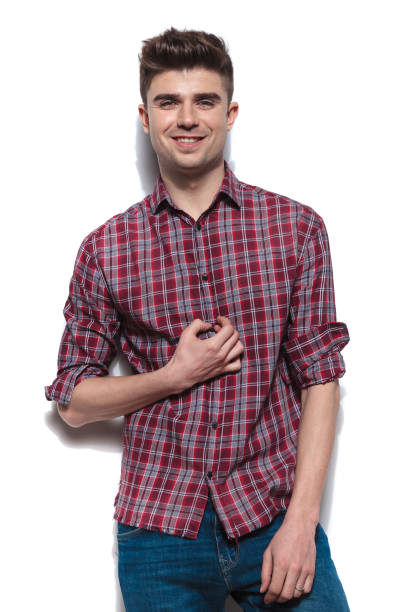 istock attractive young man buttoning his red checkers shirt 956366668