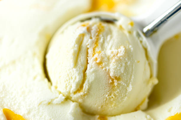 istock Vanilla ice cream scoop background. Summer food concept, copy space, top view. Scooped texture. Scooping out yellow mango ice-cream 956366866
