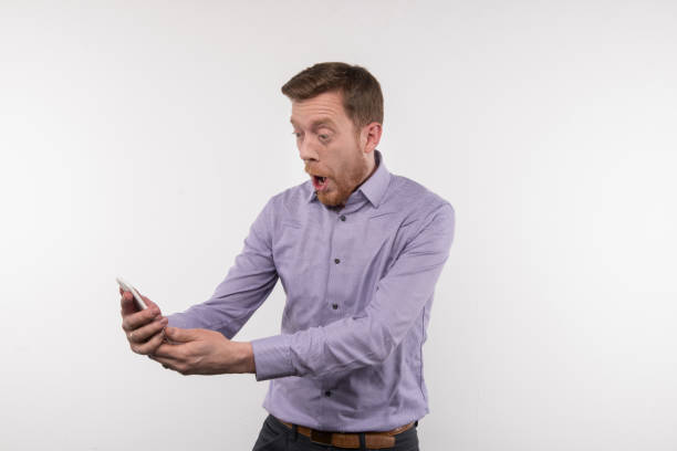 istock Happy bearded man looking at the smartphone screen 956372016
