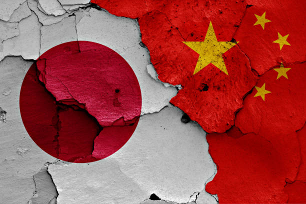 istock flags of Japan and China painted on cracked wall 956372864