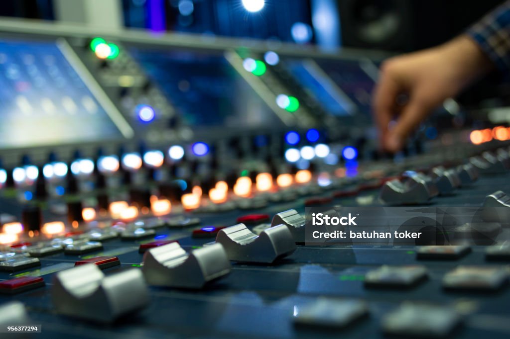 Hand on a Mixing Desk Fader in Television Gallery Sound Mixer Stock Photo