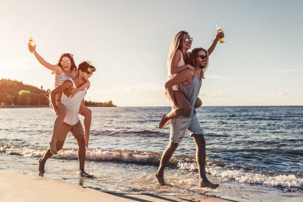 istock Group of friends on beach 956377398
