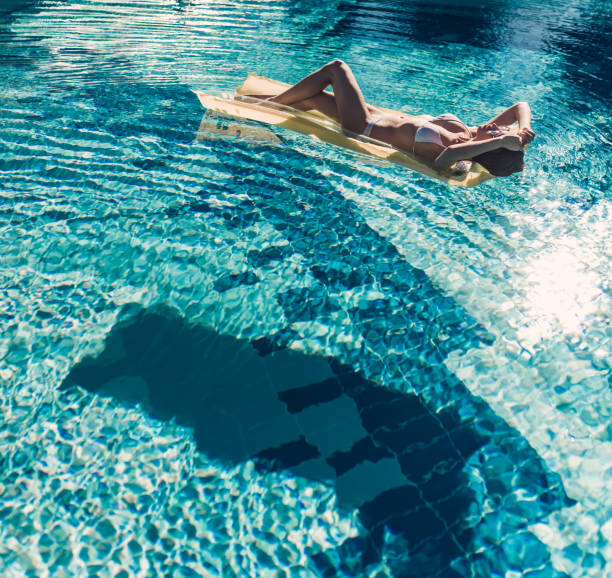istock Young woman in swimming pool 956379112