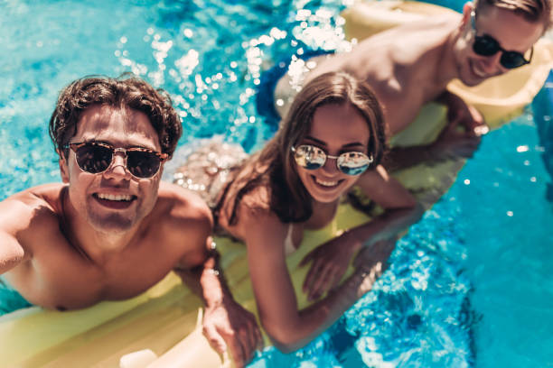 istock Young friends in swimming pool 956379162
