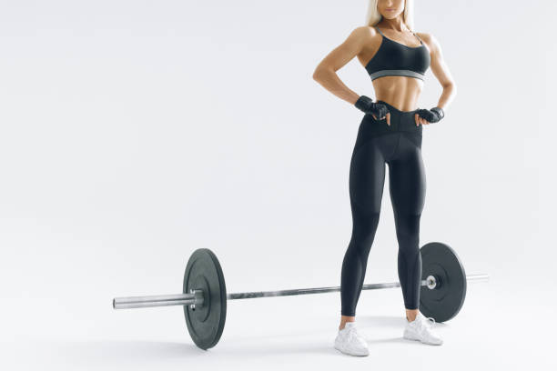 istock Fit young woman with barbell 956382688