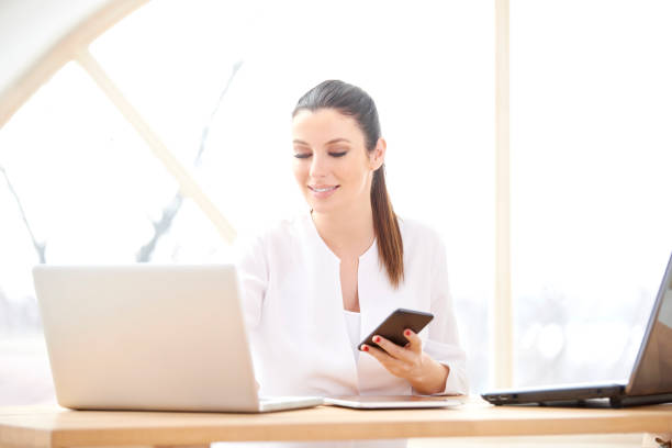 istock Businesswoman text messaging 956383440