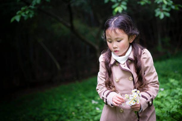 istock Little girl picking flowers 956386126