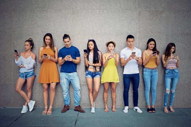 istock Friends are texting standing at the wall 956386556