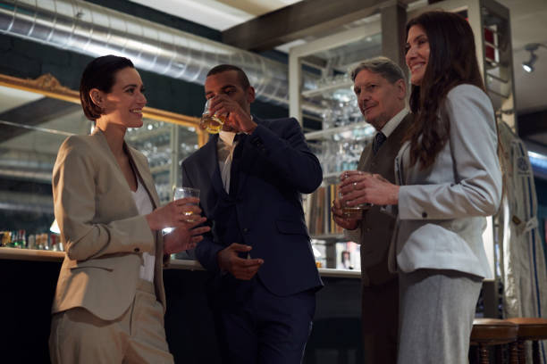 istock Business retreats, Drinking in the bar, happy hour. 956387792