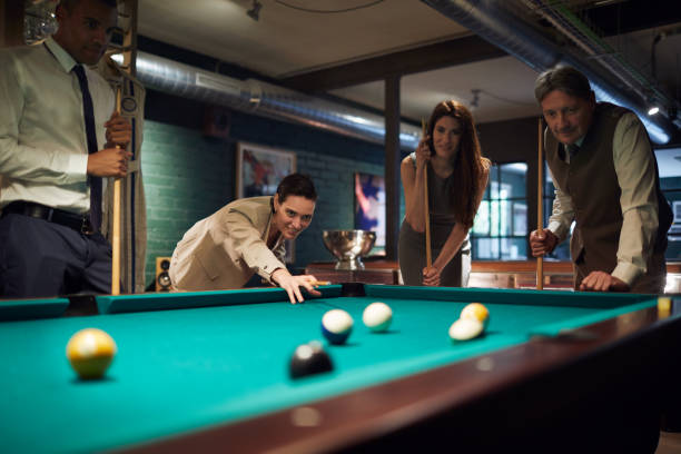 istock Playing pool after a hard work day. Business retreats. 956390070