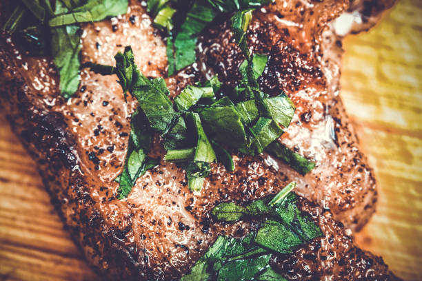 Cooked fried pork meat with parsley herb leaves garnish