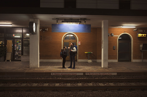 Young couple travelers waiting for train