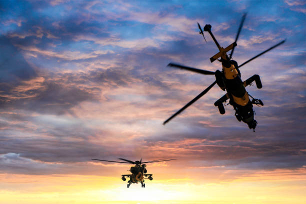 Military gunships flying against dramatic sky at sunset