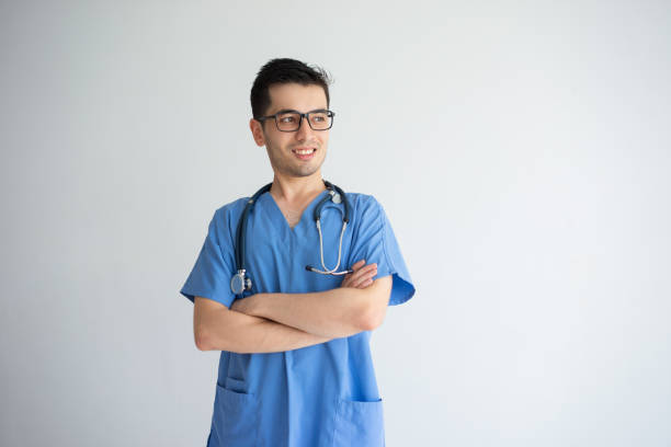 istock Smiling handsome young male doctor standing 956400680