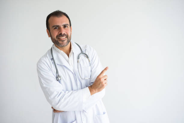 istock Portrait of happy general practitioner pointing with finger 956401176