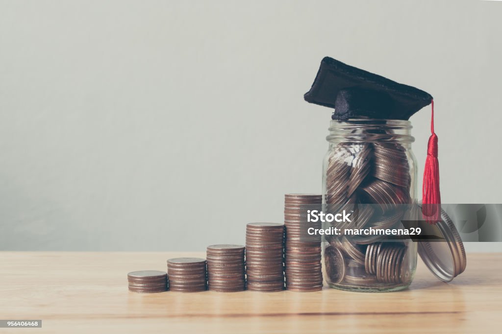 Scholarship money concept. Coins in jar with money stack step growing growth saving money investment University Stock Photo
