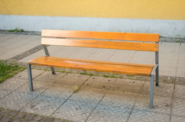 istock Empty metal and wooden bench in the town 956407686