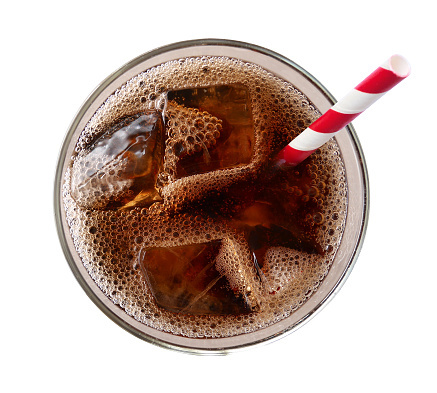Cola with ice cubes in glass top view isolated on white background, clipping path included