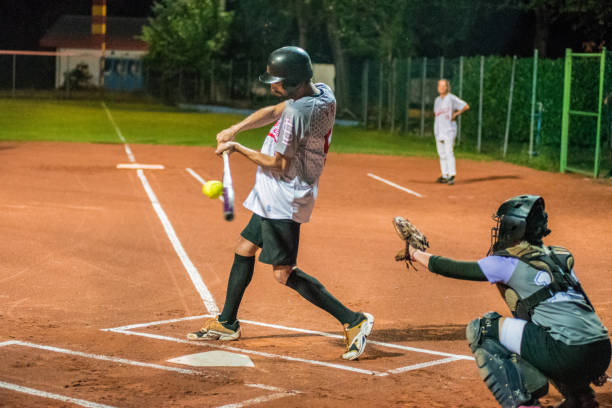 istock Softball Batter Hitting the Ball 956411496