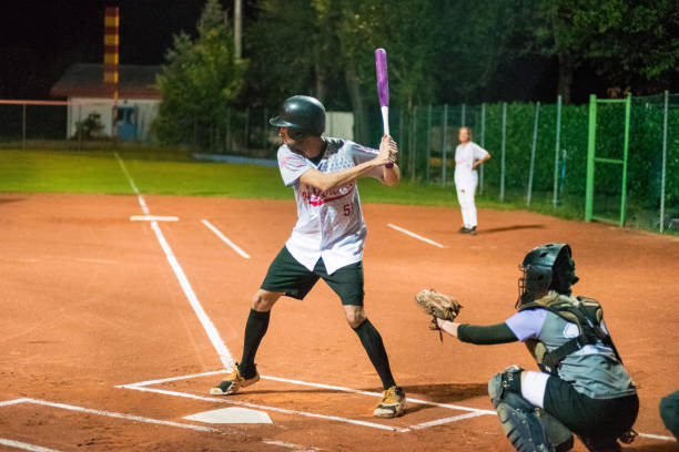 istock Softball Hitter and Catcher Waiting for Ball 956411506