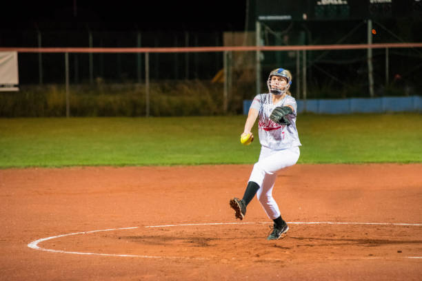 istock Woman Softball Pitcher Throwing the Ball 956411536