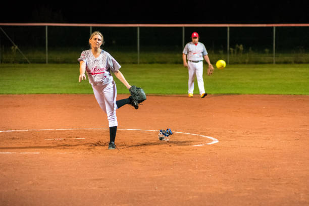 istock Woman Softball Pitcher Throwing the Ball 956411546