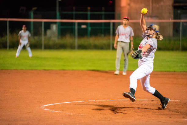 Woman Softball Pitcher Throwing the Ball Woman Softball Pitcher Throwing the Ball. softball pitcher stock pictures, royalty-free photos & images