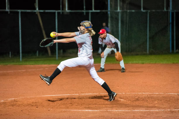 istock Woman Softball Pitcher Throwing the Ball 956411564