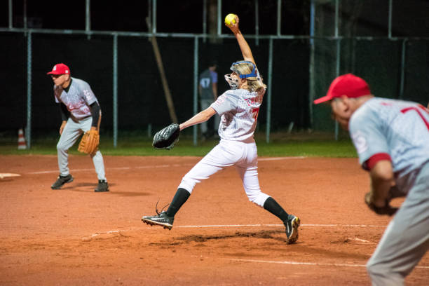 istock Woman Softball Pitcher Throwing the Ball 956411572