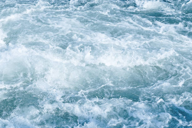 istock Abstract blue background of foamy sea wave 956414904