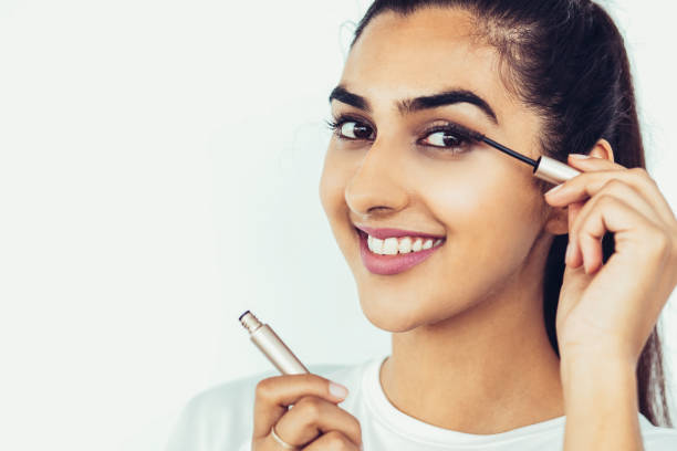 Smiling Beautiful Indian Lady Applying Mascara
