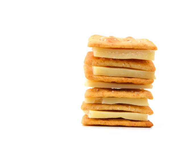 istock Delicious crackers with cheese on white background 956415696
