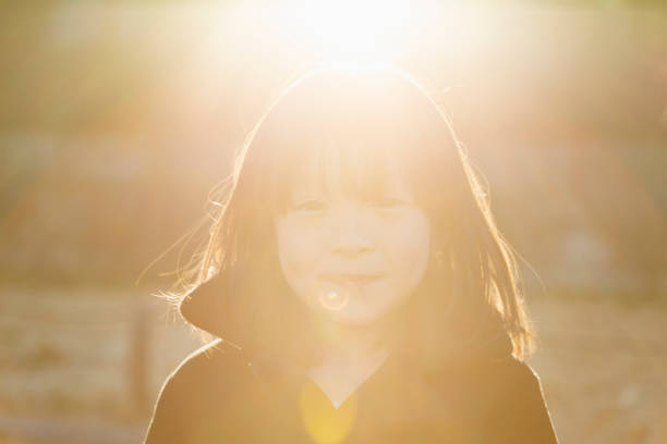 Little sibling girls on strawberry farm in spring