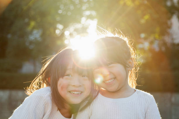 istock Portrait of Sisters with backlight 956421028