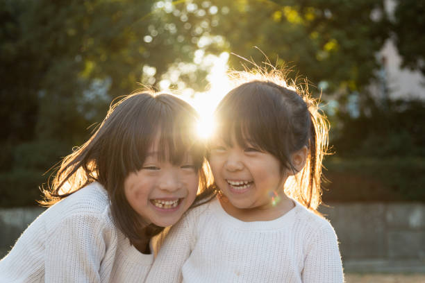 istock Portrait of Sisters with backlight 956421062