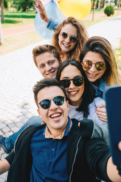 istock Best friends having fun and taking selfie at park 956421388