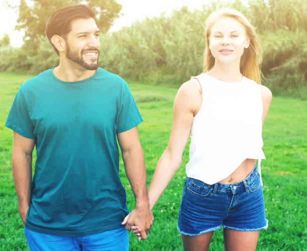 Couple in love enjoy beautiful summer day in the forest
