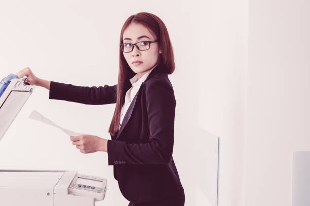istock Serious Asian businesswoman using copier in office 956426834