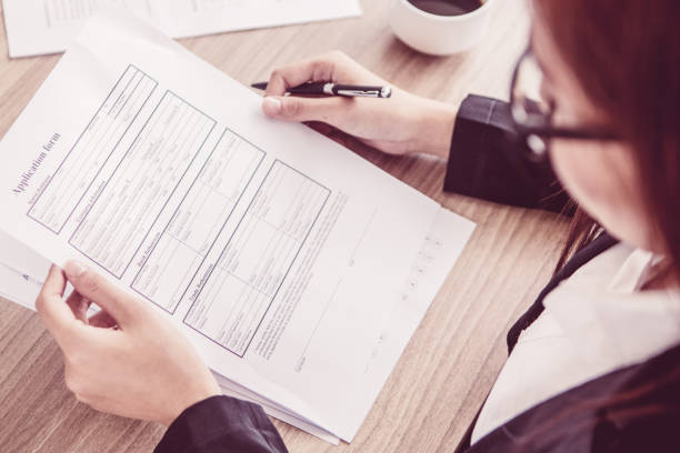 istock Young businesswoman reading application form 956426940