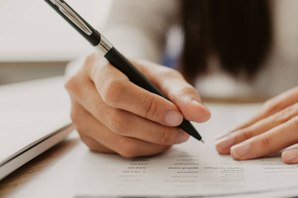 istock Cropped View of Employee Working with Document 956427066