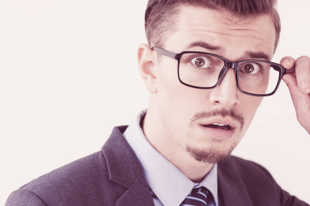 istock Scared Young Business Man Adjusting Glasses 956427156