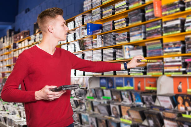 istock focused guy looking for interesting movies 956428230