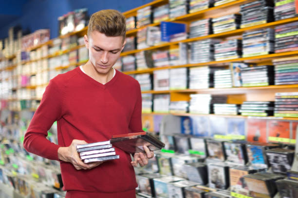 istock Glad man looking for interesting movies 956428336