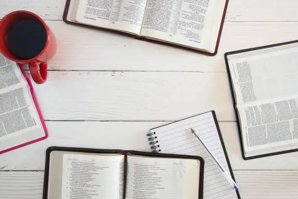 Photo of Group Bible Study on a White Wood Table