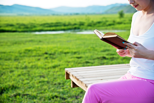 Young woman reading in the nature
