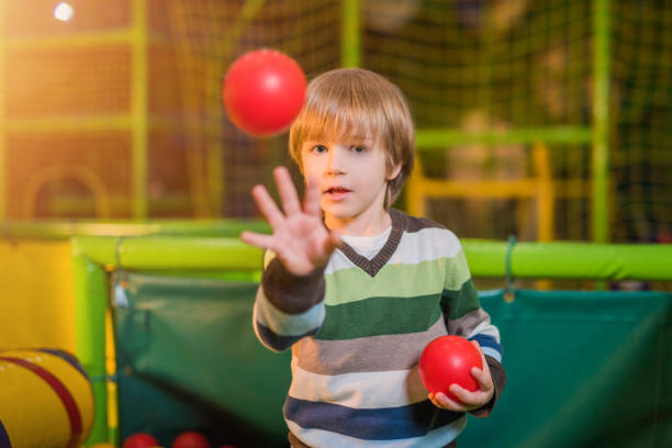 kid hand touch a red bar at play-yard in evening