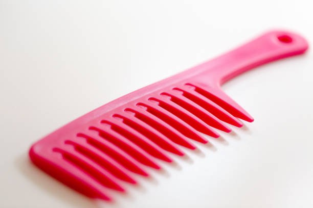 pink hair comb isolated on white background.